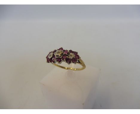 A 9ct ring ruby and diamond ring, in three clusters, 1990, Q mark, Sheffield, imported, approx. 2.3g, size K.