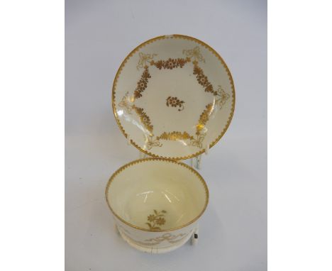 An 18th Century Worcester tea bowl and saucer, old paper labels to the base stating 'Giles Workshop 1770-75'.