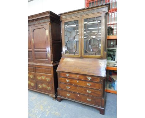 A George III mahogany bureau bookcase, the astragal glazed upper section having reeded half pilasters and interior drawers, t
