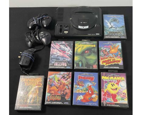 SEGA MEGA DRIVE - An unboxed Sega Mega Drive console with 2 original controllers and power supply together with 8 boxed video
