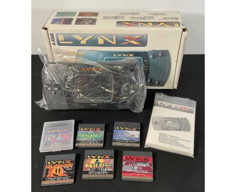An ATARI LYNX handheld games console, boxed in original packaging with instructions and 6 games, Ninja Gaiden, Ms. Pac-Man, B