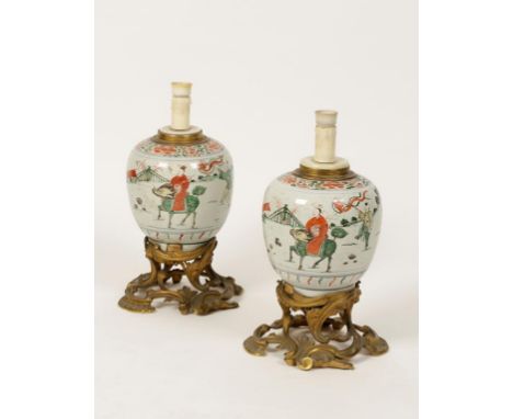 A PAIR OF CHINESE FAMILLE VERTE PORCELAIN OVOID JARS, each painted with a sage riding a Kylin accompanied by four boy attenda