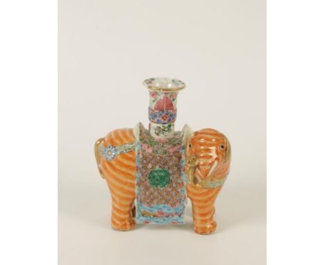 A CHINESE FAMILLE ROSE PORCELAIN ELEPHANT JOSS STICK HOLDER, modelled standing with turned head, with orange hide and floral 