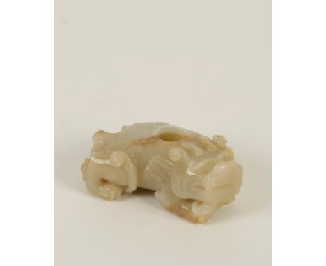 A CHINESE MOTTLED FAUN JADE RECUMBENT LION with scrolls emanating from it's limbs, Ming style, 8.5cm long. Condition report A