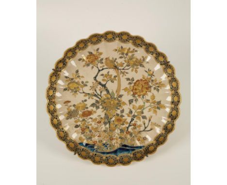 A SATSUMA EARTHENWARE SHALLOW DISH, signed Gyokuzan, of chrysanthemum outline, painted and gilded with a pheasant perched on 