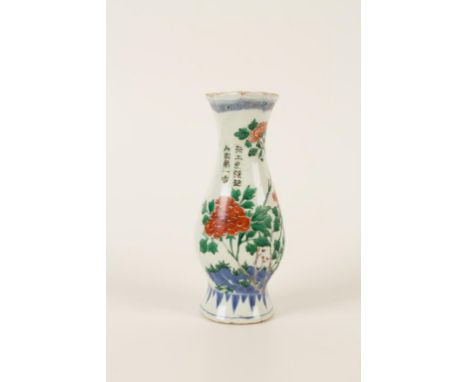 A CHINESE WUCAI PORCELAIN WALL POCKET, Kangxi (1662-1722), of baluster shape, painted with peonies growing from rocks flanked