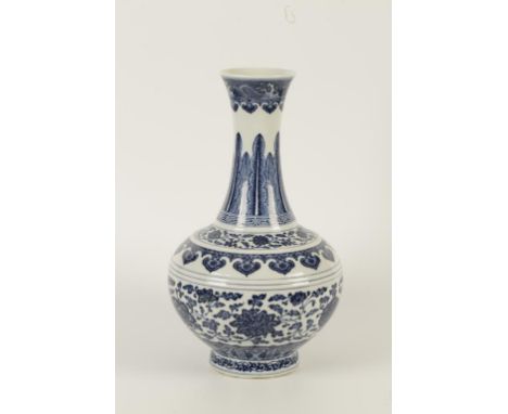 A CHINESE BLUE AND WHITE PORCELAIN BOTTLE VASE with globular body and waisted neck, painted in 'heaping and piling' technique