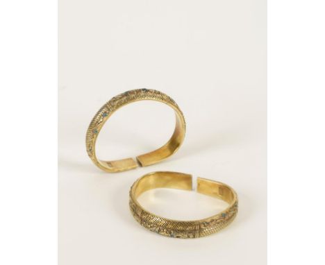 A PAIR OF CHINESE GILT METAL AND ENAMELLED BANGLES each with ten panels of foliage, bats and abstract patterns, 7cm wide. Con