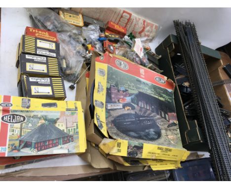 A box containing OO/HO scale railway accessories including track, trackside building kits , 2x R997 preformed layouts boxed, 