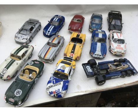 A collection of loose 1:18 scale loose Diecast vehicles including Jaguars, Porsche, Bugatti, Mercedes Benz etc