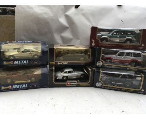 A collection of boxed 1:18 scale Diecast vehicles including Revell Mercedes Benz 500SL coupe and a Mercedes Benz 500SL conver