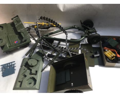 Action man, a box containing a collection of spare parts including accessories and vehicle parts