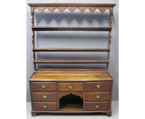 19TH CENTURY OAK OPEN RACK TWO STAGE DRESSER having moulded cornice with shaped sides above three shelves, the moulded base a