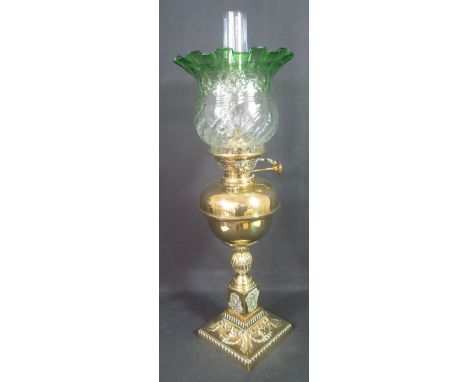 EARLY 20TH CENTURY ALL BRASS OIL LAMP with brass reservoir on fluted baluster stem with repousse and relief decorated square 