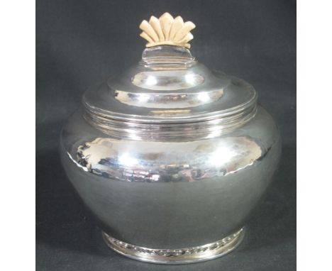 20TH CENTURY SILVER TEA CADDY, of ovoid form with hinged lid and beaten finish with gilded interior and geometric finial, Lon