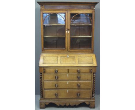 EARLY 19TH CENTURY WELSH OAK BUREAU BOOKCASE having moulded cornice over mahogany veneered frieze with turned bullions, two a