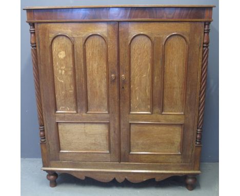 VICTORIAN MAHOGANY CUPBOARD having moulded top above two arch moulded blind panelled doors flanked by pilaster supports with 