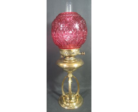 LATE 19TH/EARLY 20TH CENTURY BRASS DOUBLE BURNER OIL LAMP having pierced gallery above baluster shaped reservoir on three out