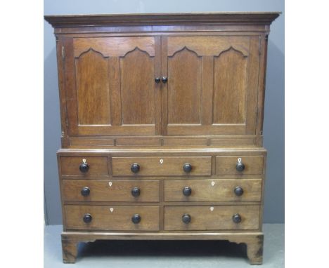 19TH CENTURY WELSH OAK TWO STAGE LINEN PRESS CUPBOARD having moulded cornice above two blind panelled doors with ogee fielded