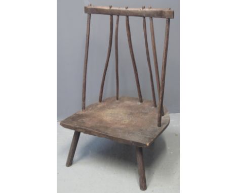 STAINED RUSTIC PRIMITIVE LOW STICK BACK CHAIR having moulded seat on tapering turned legs. (B.P. 24% incl. VAT) CONDITION REP