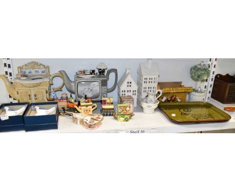 A shelf of assorted decorative ceramics including various novelty teapots, Emma Bridgewater egg cups, pottery tray, etc. Loca