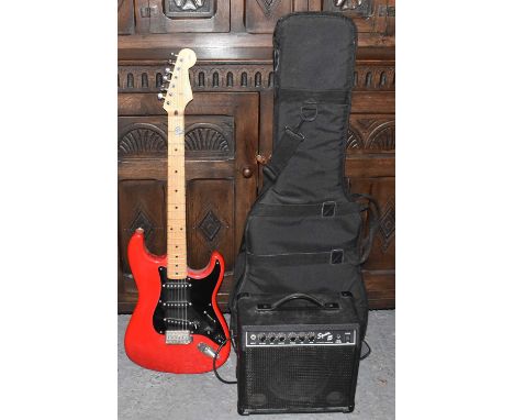 SQUIER BY FENDER; a silver series Stratocaster electric guitar in red, with case, Squier 15 amplifier, stand, etc.