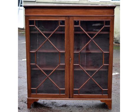 An Edwardian mahogany display cabinet with moulded caddy top above two astragal glazed doors, enclosing adjustable shelves, h