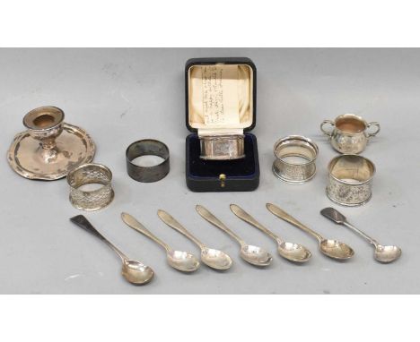 A mixed lot of hallmarked silver including five assorted napkin rings, various spoons, and a small candlestick, approx 9ozt/2