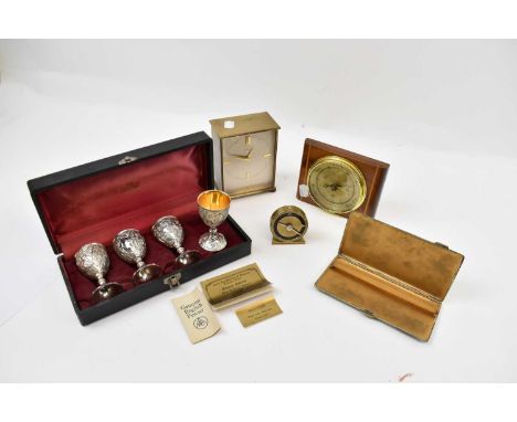 A Garrard clock, a cased set of four pewter goblets, inlaid barometer, cigarette case, and a Cyma alarm clock (5).