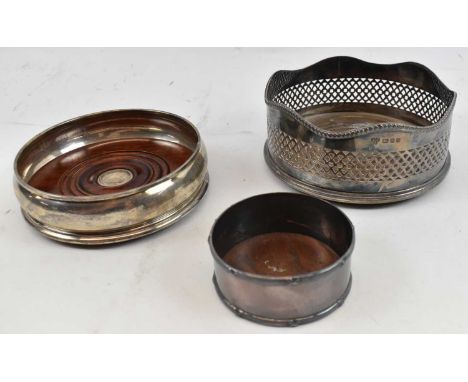 An Elizabeth II hallmarked silver pierced bottle coaster, London 1968, diameter 13cm, with two further bottle coasters (3).