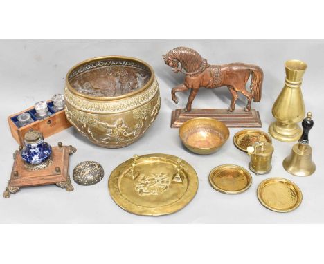 A small group of metalware including a heavy polished gilt metal vase, embossed brass jardiniere, an inkwell, door stop, grin