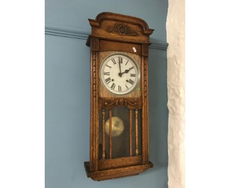 Lovely Art Deco solid oak wall clock with key and pendulum, In a Running condition. 