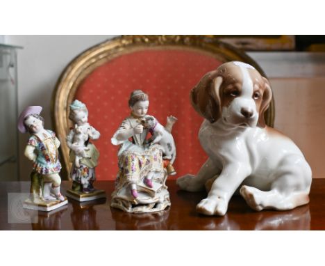 A Meissen figure of a seated girl, feeding a cat on her lap, 13 cm high, to/w two other small figures of children, AR monogra