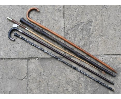 A walking stick with silver mounts, to/w an officer's riding crop with Royal Signals badge, a cane with mother of pearl inlay