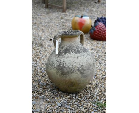 An old weathered twin handled amphora style garden urn 