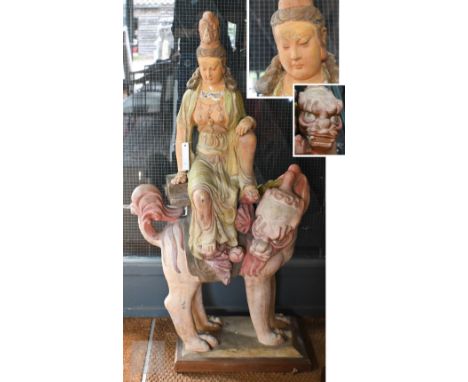 A large Thai polychrome glazed pottery figure of Guanyin seated on the back of a mythical beast, 126 cm h, some minor surface