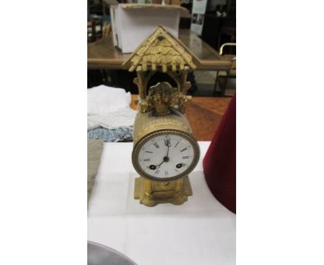 A 19th century gilt clock in working order but missing glass.