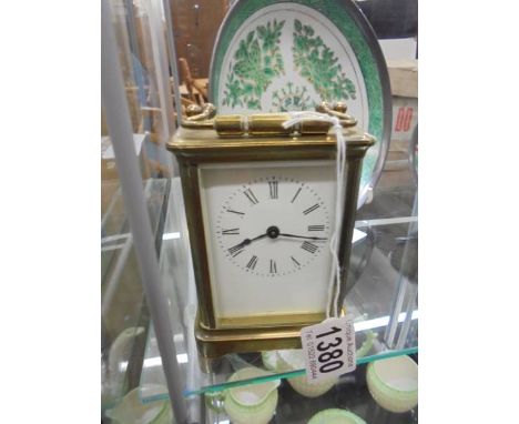 A brass carriage clock, springs ok but would benefit from a clean.