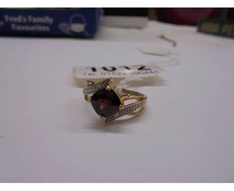 A 9ct gold ruby and diamond ring, size M, 2.9 grams.