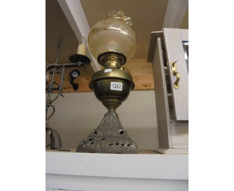 An old oil lamp on cast base with brass font. COLLECT ONLY.