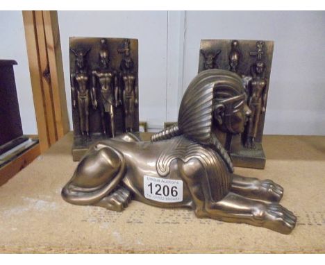 A model of a Sphinx and two other Egyptian figures.