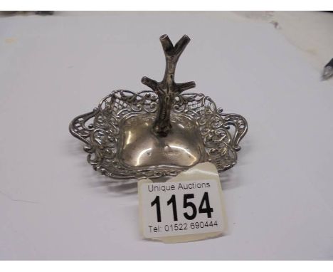 A silver ring tree with trinket dish base, circa 1900.