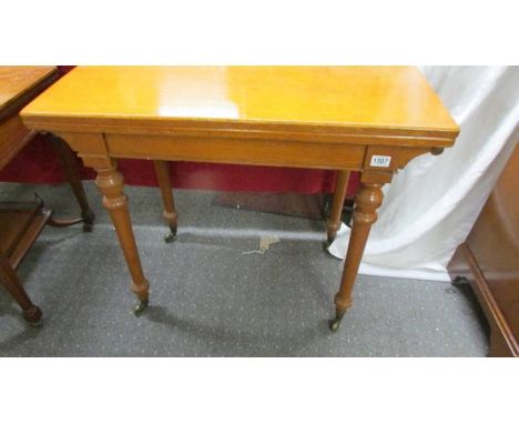 A light oak fold over games table on castors, COLLECT ONLY.