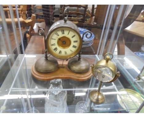 An old brass clock in working order but missing one hand and glass together with another brass clock.