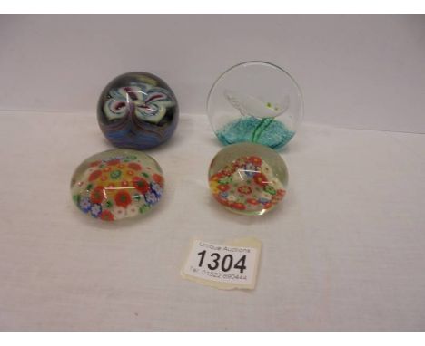 A Caithness limited edition 93/500 Salmon paperweight, two millifiori paperweights and one other.