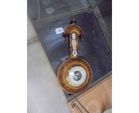 A small wall hanging barometer/thermometer.