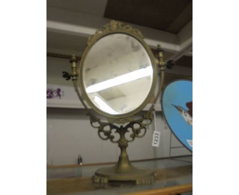 A brass framed swivel mirror.