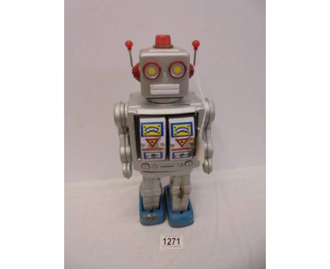 A vintage tinplate Japanese battery operated walking/shooting robot, working when tested, 31 cm tall.