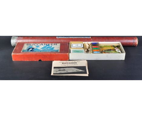 An vintage first edition Waddingtons ' Buccaneer ' tabletop game with large rolled map, chance cards, sailing boat playing pi