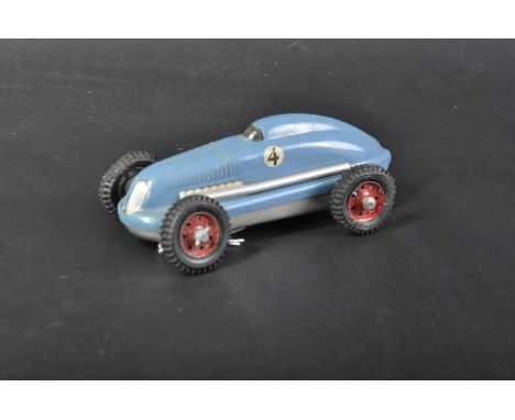 A vintage German believed Schuco tinplate model racing car. Blue exterior with No. 4 racing number.